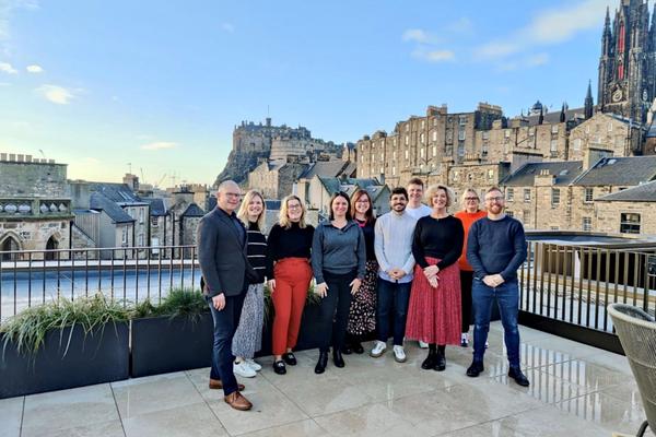 The Business Events team at Virgin Hotels Edinburgh with view of the Edinburgh Castle
